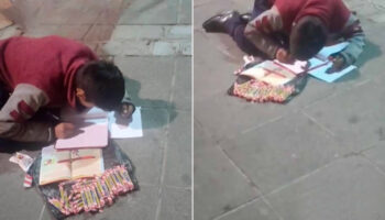 Menino é visto fazendo lição de casa enquanto vende doces na rua